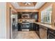 Well-equipped kitchen featuring stainless steel appliances and dark cabinets at 9445 N 106Th St, Scottsdale, AZ 85258