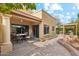 Inviting outdoor patio area with a dining set, lush landscaping, and stucco walls for relaxation and entertainment at 9445 N 106Th St, Scottsdale, AZ 85258