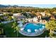 Aerial view of a community pool with lounge seating and mountain views at 9445 N 106Th St, Scottsdale, AZ 85258