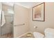 Well-lit bathroom featuring a tiled shower with a glass door and grab bars at 9445 N 106Th St, Scottsdale, AZ 85258