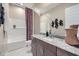 This bathroom features granite counters, modern fixtures, and a tub/shower with decorative curtain at 974 W Saddle Run, Apache Junction, AZ 85120