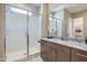 Bright bathroom featuring a walk-in shower with marble surround and granite countertops at 974 W Saddle Run, Apache Junction, AZ 85120