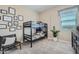 Bedroom featuring a bunk bed, neutral walls decorated with art, and large window for natural light at 974 W Saddle Run, Apache Junction, AZ 85120