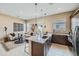 Open concept kitchen and living room with stone countertops and comfortable seating at 974 W Saddle Run, Apache Junction, AZ 85120