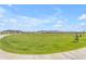 Expansive green park area under a bright blue sky, perfect for recreation and relaxation at 974 W Saddle Run, Apache Junction, AZ 85120