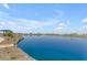 Picturesque view of the lake, showcasing the tranquil community lake under a partly cloudy sky at 974 W Saddle Run, Apache Junction, AZ 85120