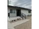 Contemporary home featuring a striking black front door, complemented by modern railings and low-maintenance yard at 9810 N 2Nd Way, Phoenix, AZ 85020