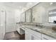 Bright bathroom featuring double sink vanity with granite countertops and wood tile flooring at 9823 E Red Giant Dr, Mesa, AZ 85212