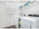 Bright laundry room featuring modern appliances and ample shelving for storage of laundry supplies at 9823 E Red Giant Dr, Mesa, AZ 85212