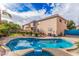 This backyard features a refreshing swimming pool with desert landscaping at 11023 E Florian Ave, Mesa, AZ 85208