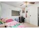 Cozy bedroom featuring a ceiling fan, a small desk, and natural light from a window at 11023 E Florian Ave, Mesa, AZ 85208