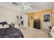 Neutral toned bedroom with a ceiling fan, and yellow accent wall at 11023 E Florian Ave, Mesa, AZ 85208