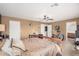 Spacious bedroom with a ceiling fan and comfortable bed at 11023 E Florian Ave, Mesa, AZ 85208