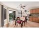 Cozy dining area with wood floors, a sliding glass door to the yard, and a chandelier at 11023 E Florian Ave, Mesa, AZ 85208