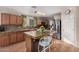 Well-equipped kitchen with a central island, updated appliances, and stylish countertops for cooking enjoyment at 11023 E Florian Ave, Mesa, AZ 85208