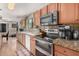 Functional kitchen with ample counter space, modern appliances, and abundant storage in wooden cabinets at 11023 E Florian Ave, Mesa, AZ 85208