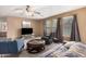 Bright living room with a large window, comfortable seating, and a wall-mounted television for entertainment at 11023 E Florian Ave, Mesa, AZ 85208