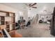 Bright living room showcasing a comfortable seating area, carpet and view of the staircase at 11023 E Florian Ave, Mesa, AZ 85208