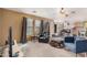 Inviting living room boasts carpet, dark blinds, and natural light at 11023 E Florian Ave, Mesa, AZ 85208