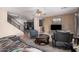 Open-concept living room with a view of the staircase, comfortable seating, and neutral color palette at 11023 E Florian Ave, Mesa, AZ 85208