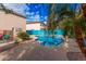 This backyard features a sparkling blue swimming pool surrounded by lush landscaping at 11023 E Florian Ave, Mesa, AZ 85208