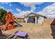Backyard features a playground and picnic table with plenty of space for children and entertaining at 11813 W Sierra St, El Mirage, AZ 85335