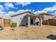 Backyard view with patio, landscaping, fencing and a covered porch perfect for relaxing outdoors at 11813 W Sierra St, El Mirage, AZ 85335