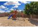 Backyard features a playground with swings, slide, and fort, perfect for outdoor fun and activities at 11813 W Sierra St, El Mirage, AZ 85335