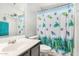 Bathroom featuring a toilet, shower with patterned curtain, sink, and cabinets at 11813 W Sierra St, El Mirage, AZ 85335