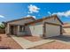 Inviting home featuring a well-maintained front yard and a convenient two-car garage at 11813 W Sierra St, El Mirage, AZ 85335