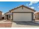 Charming home featuring a well-maintained front yard and a convenient two-car garage at 11813 W Sierra St, El Mirage, AZ 85335