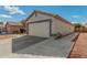 Home with a spacious two-car garage and well-maintained exterior at 11813 W Sierra St, El Mirage, AZ 85335