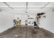 Spacious garage with white walls and overhead door, containing the laundry and cleaning area at 11813 W Sierra St, El Mirage, AZ 85335