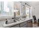 Kitchen featuring stainless steel sink, stainless steel dishwasher, gray cabinets, and a window at 11813 W Sierra St, El Mirage, AZ 85335