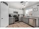 Modern kitchen featuring stainless steel appliances, gray cabinets, and stylish pendant lighting at 11813 W Sierra St, El Mirage, AZ 85335