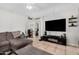 Comfortable living room with tile floors, a ceiling fan, and ample natural light at 11813 W Sierra St, El Mirage, AZ 85335