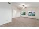 Spacious carpeted bedroom boasts natural light from dual windows and features a ceiling fan at 11991 N 69Th Ave, Peoria, AZ 85345