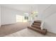 Bright living room with carpet, staircase, vaulted ceilings, and lots of natural light at 11991 N 69Th Ave, Peoria, AZ 85345