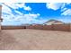 Large, empty backyard with block wall and a view of neighboring houses at 12378 W Marguerite Ave, Avondale, AZ 85323