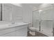 Bathroom featuring a glass-enclosed shower, modern vanity, and a mirror at 12378 W Marguerite Ave, Avondale, AZ 85323