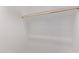 Close-up of a white closet with a single wood shelf support at 12378 W Marguerite Ave, Avondale, AZ 85323
