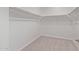 Walk-in closet with carpeted floor and shelving at 12378 W Marguerite Ave, Avondale, AZ 85323