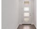 Bright entryway showcases a modern white door with glass panels and wood-look flooring at 12378 W Marguerite Ave, Avondale, AZ 85323