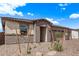 Attractive home exterior with desert landscaping, a covered entry, and three-car garage at 12378 W Marguerite Ave, Avondale, AZ 85323