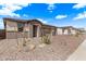 Beautiful home exterior features desert landscaping and a three-car garage at 12378 W Marguerite Ave, Avondale, AZ 85323