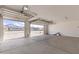 Open garage showcasing its spacious interior with a view of the neighborhood at 12378 W Marguerite Ave, Avondale, AZ 85323