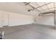 Spacious garage featuring an automatic door, lighting, and white walls at 12378 W Marguerite Ave, Avondale, AZ 85323