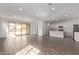 Open-concept living space combines the living room and kitchen, featuring wood-look tile flooring at 12378 W Marguerite Ave, Avondale, AZ 85323