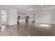 Spacious living area with wood-look tile connects to the open-concept kitchen with stainless steel appliances at 12378 W Marguerite Ave, Avondale, AZ 85323
