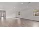 Expansive living area showcasing wood-look tile flooring, recessed lighting, and abundant natural light at 12378 W Marguerite Ave, Avondale, AZ 85323